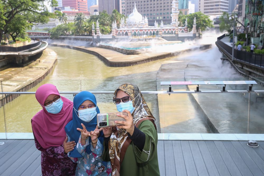 People pose for pictures at Masjid Jamek on the first day of Raya May 13, 2021. u00e2u20acu201d Picture by Choo Choy May