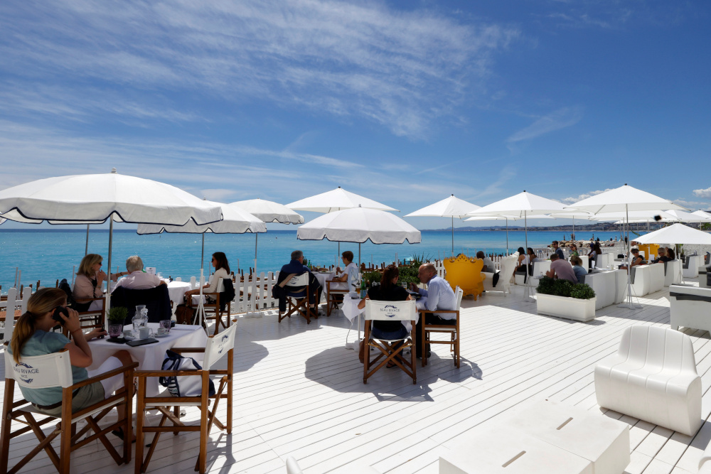 Customers enjoy a lunch on the terrace of a beach restaurant in Nice as cafes, bars and restaurants reopen after closing down for months amid the Covid-19 outbreak in France, May 19, 2021. u00e2u20acu201d Reuters pic