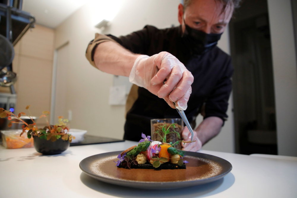 French chef Laurent Veyet prepares a dish made with mealworms in his restaurant Inoveat serving insect-based food in Paris May 12, 2021. u00e2u20acu201d Reuters pic