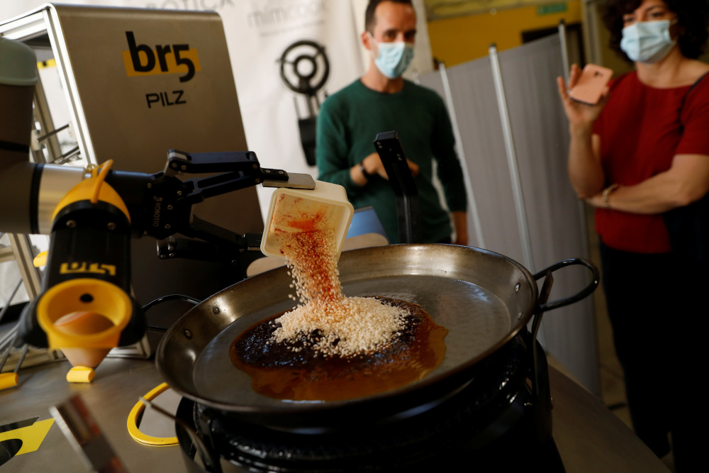 Chef Maria Munoz watches as a robot created by Spanish companies br5 and Mimcook makes paella during a demonstration at a warehouse in San Fernando de Henares May 20, 2021. u00e2u20acu201d Reuters pic