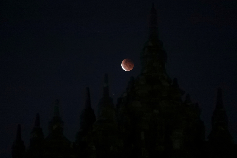 The full moon, known as u00e2u20acu02dcSuper Blood Moonu00e2u20acu2122, rises over the Plaosan temple, one of the Buddhist temples, which estimated was built in the 9th century, during total lunar eclipse in Klaten regency, Central Java province May 26, 2021. u00e2u20acu201d Reuters pic