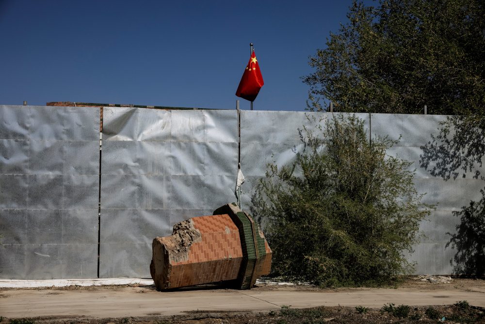 A part of a minaret broken off from the former Xinqu Mosque lies near a Chinese national flag in a yard adjacent to the former house of worship in Changji, Xinjiang Uyghur Autonomous Region May 6, 2021. u00e2u20acu201d Reuters pic