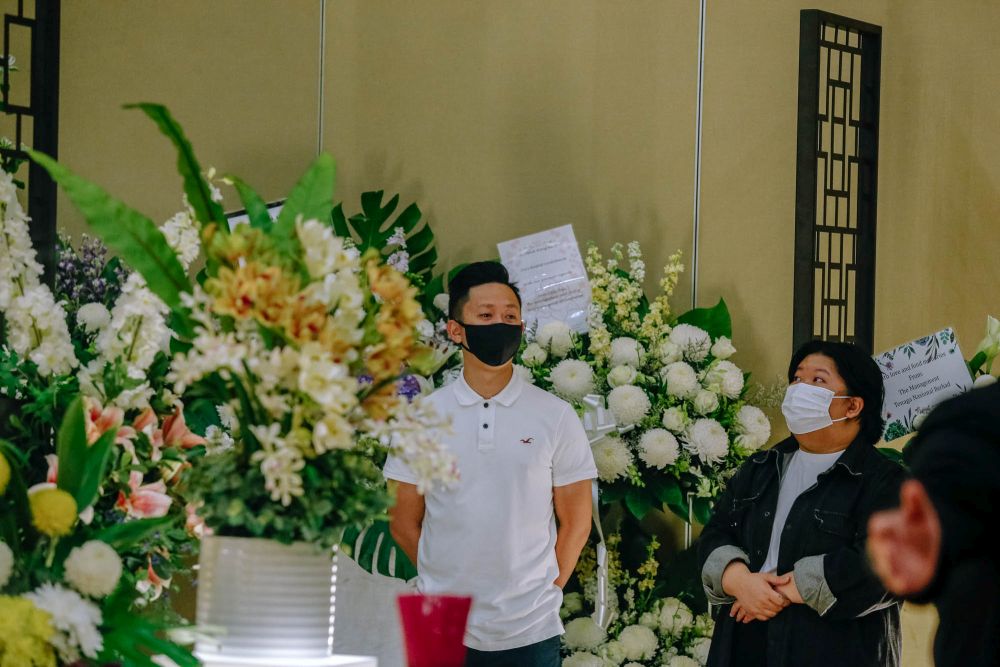 Wong Chee Mun and his sister Yik Pen are pictured as mourners take their turn to view Sai Wan's remains one final time at the Xiao En Centre in Jalan Kuari, Cheras May 17, 2021. — Picture by Firdaus Latif