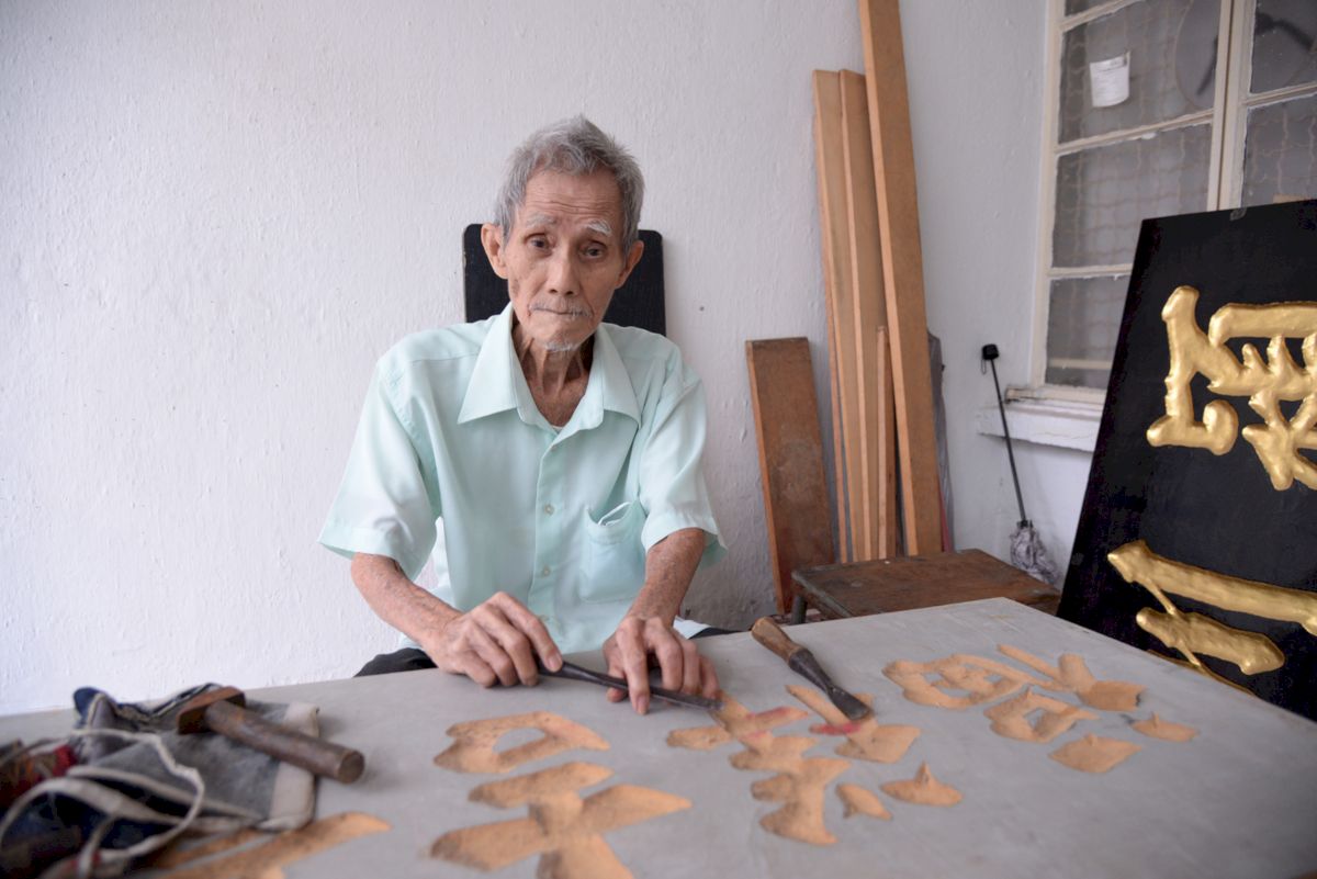 At 83, Kok Ah Wah can still carve a traditional signboard. u00e2u20acu201d Pix by Steven Ooi KE