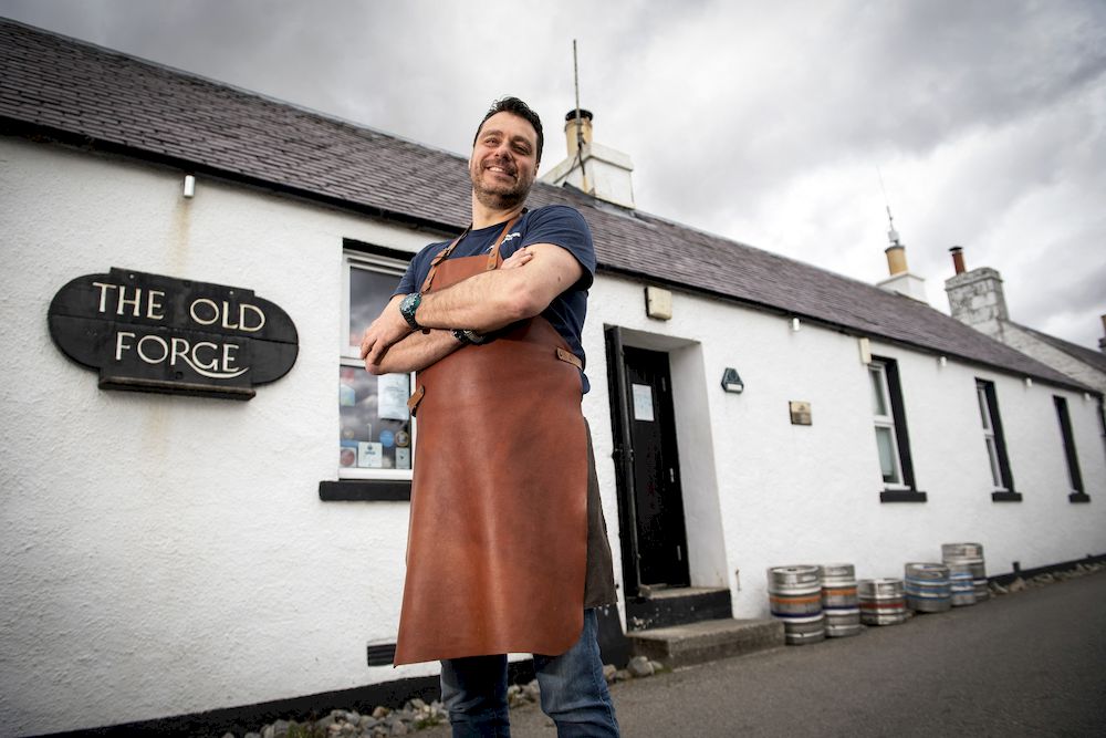 Jean-Pierre Robinet, owner of The Old Forge, poses for a photograph outside his pub in Inverie on the Knoydart peninsular in the Scottish Highlands. u00e2u20acu201d AFP pic