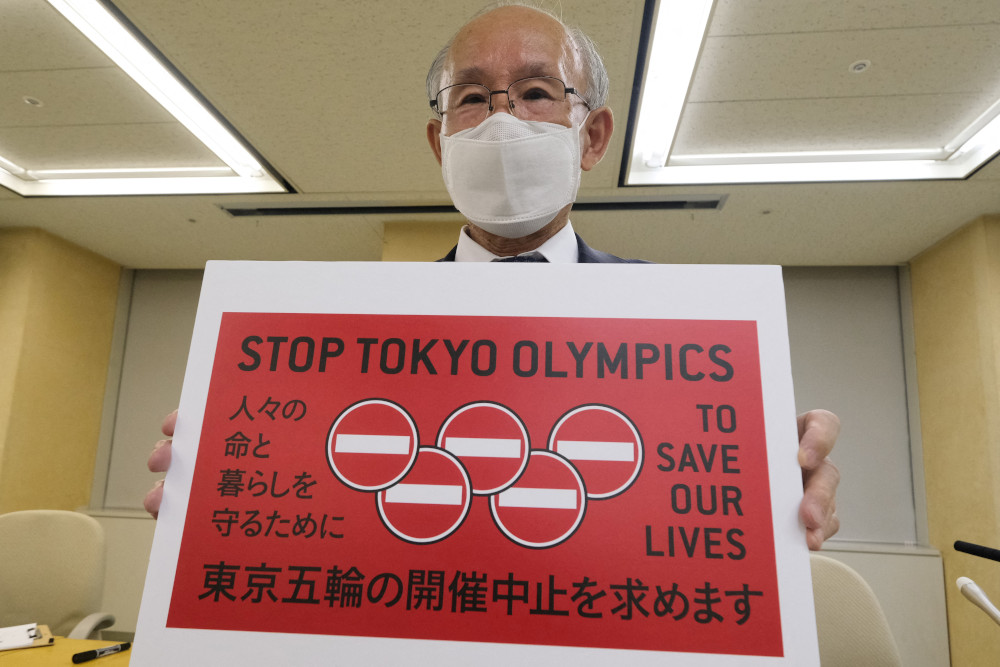 This picture taken May 14, 2021 shows Kenji Utsunomiya, a Japanese lawyer and former Tokyo gubernatorial candidate, displaying a campaign poster calling for the cancellation of the Tokyo Olympics in Tokyo. u00e2u20acu201d AFP pic 