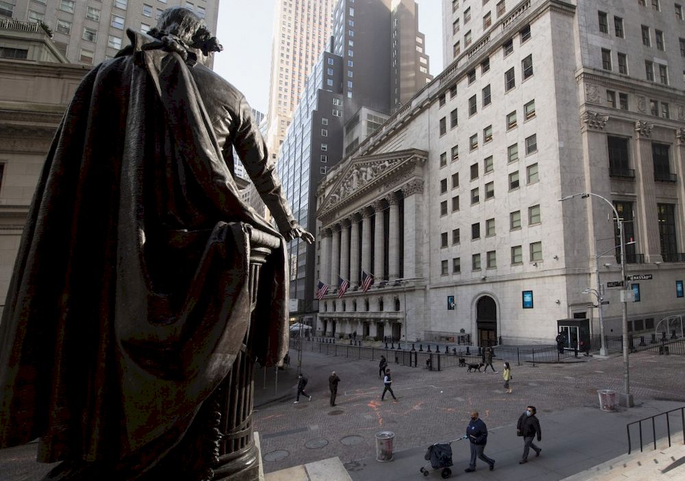 In this file photo people walk past the New York Stock Exchange (NYSE) and a statue of George Washington at Wall Street on March 23, 2021 in New York City. u00e2u20acu201d AFP pic
