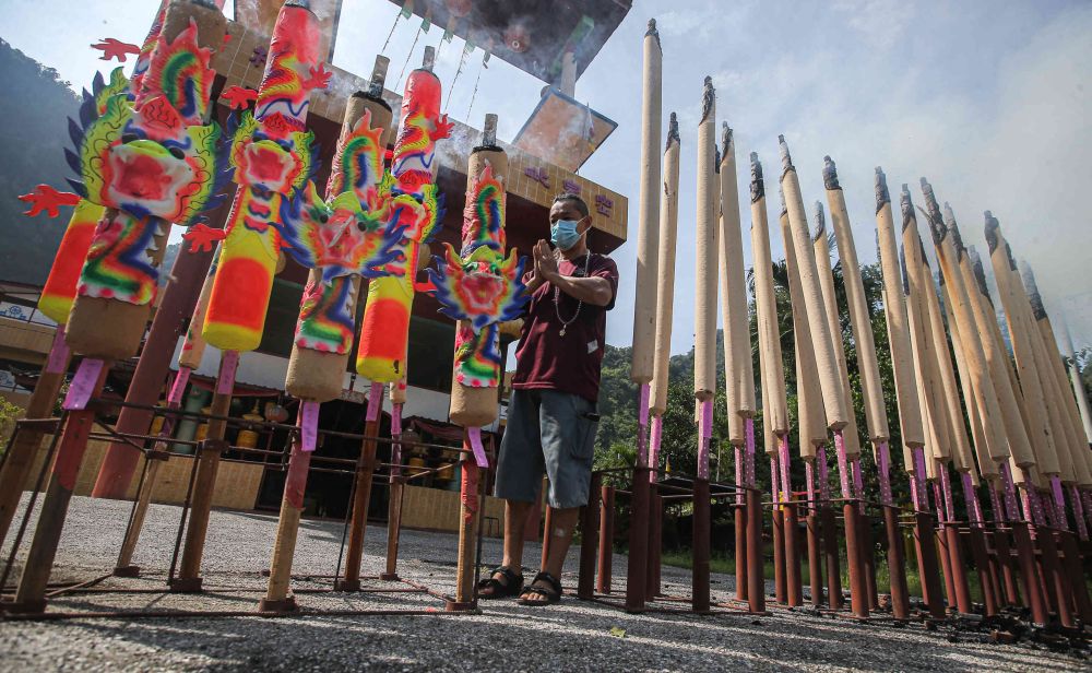 A Buddhist temple committee member offers prayers on Wesak Day in Ipoh May 26, 2021. u00e2u20acu201d Picture by Farhan Najib