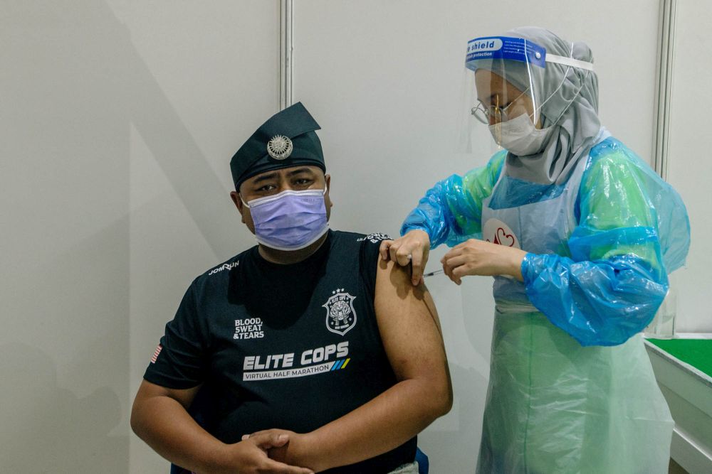A nurse administers a dose of the AstraZeneca Covid-19 vaccine at the World Trade Centre Kuala Lumpur vaccination centre May 16, 2021. u00e2u20acu201d Picture by Firdaus Latif