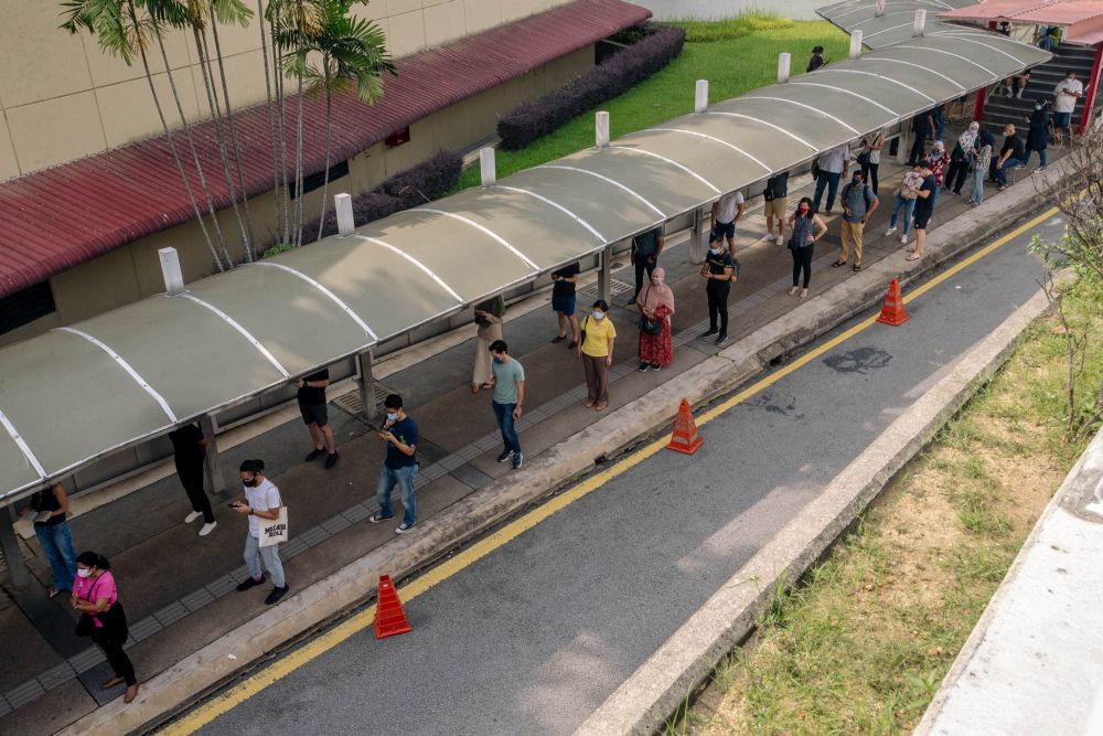 People queue outside the World Trade Centre Kuala Lumpur as they wait to receive the AstraZeneca Covid jab May 16, 2021. u00e2u20acu2022 Picture by Firdaus Latifnn
