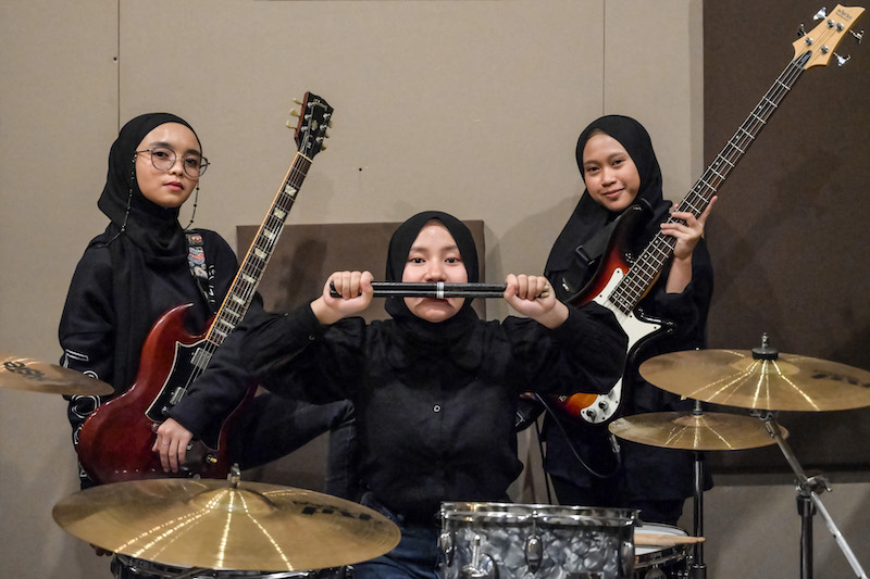 Members of the Indonesian heavy metal band Voice of Baceprot (VOB), (from left) guitarist and vocalist Firda Marsya Kurnia, drummer Euis Siti Aisah and bassist Widi Rahmawati pose for photos after a practice session in Jakarta. u00e2u20acu201d AFP pic