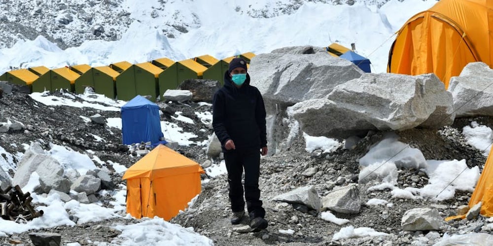 An expedition base camp staff wearing a facemask walks around Everest base camp, some 140km northeast of Kathmandu. u00e2u20acu201d AFP pic