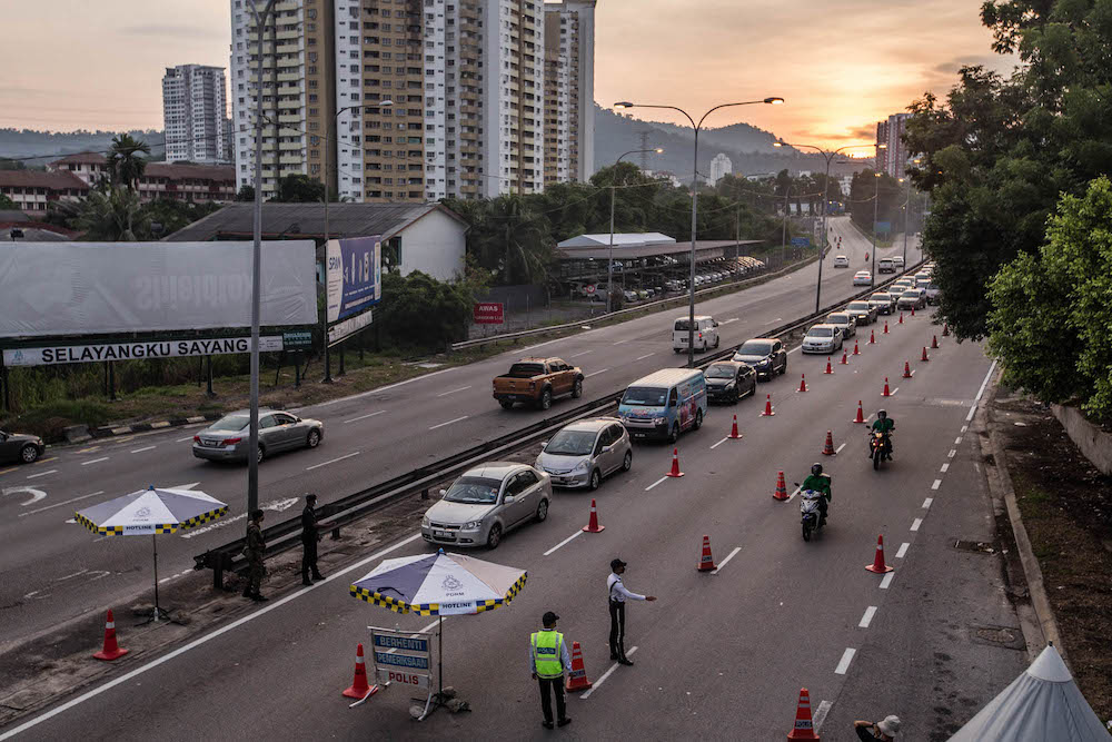 Police and Armed Forces personnel conduct checks on vehicles at a roadblock on Jalan Ipoh-Rawang June 6, 2021. u00e2u20acu201d Picture by Firdaus Latif