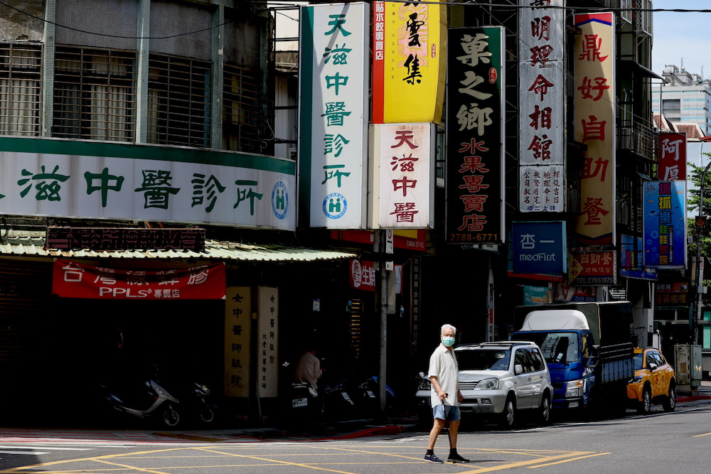 A man crosses the street while wearing a protective mask following the recent rise in Covid-19 infections in Taipei, Taiwan June 2, 2021. — Reuters pic
