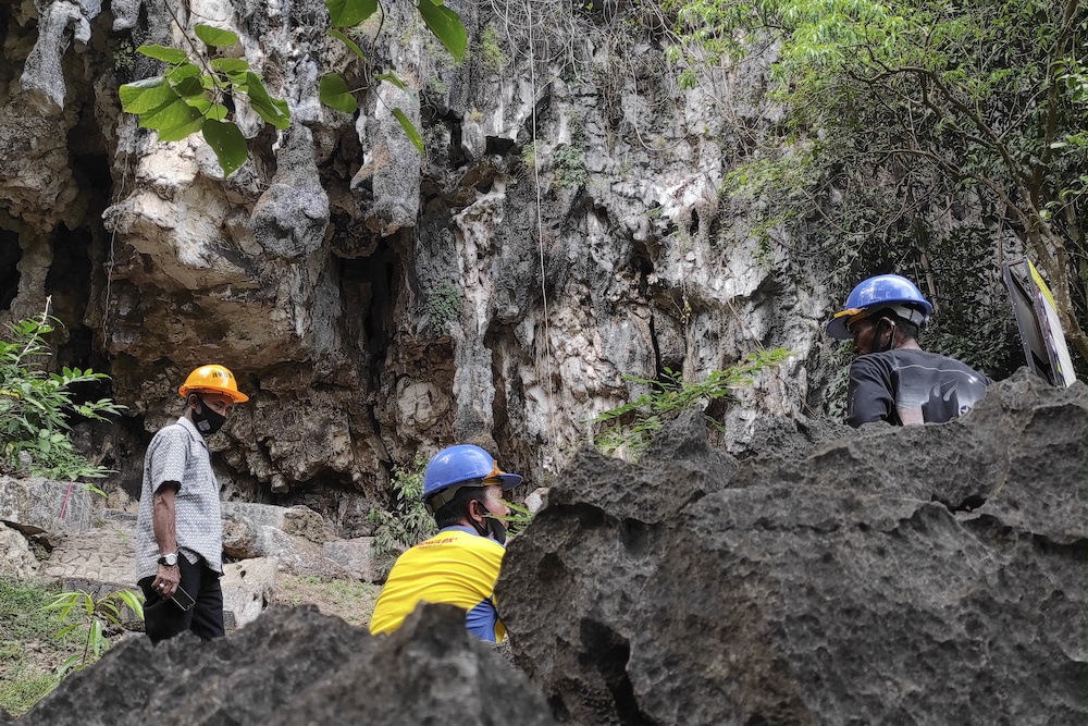 Archeologists gather while inspecting the world's oldest limestone cave painting, which is decaying at a rapid pace due to climate change, in Maros regency, South Sulawesi province, Indonesia, May 27, 2021. u00e2u20acu201d Reuters pic