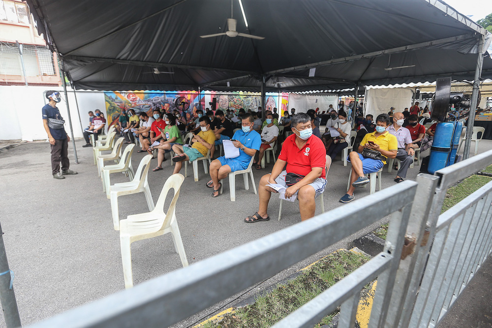 Traders and local workers at Pasar Borong Kuala Lumpur wait to receive their Covid-19 vaccination through the MYMedic@Wilayah Vaccine Mobile Truck programme in Selayang June 20, 2021. u00e2u20acu201d Picture by Yusof Mat Isa