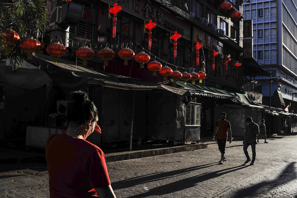 The relatively quiet streets of Kuala Lumpur's Chinatown with reduced foot traffic amid the total lockdown. — Picture by Shafwan Zaidon