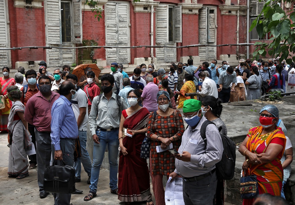 People wearing protective face masks wait to receive their second dose of Covishield, a Covid-19)vaccine manufactured by Serum Institute of India, outside a vaccination centre in Kolkata May 12, 2021. u00e2u20acu201d Reuters pic