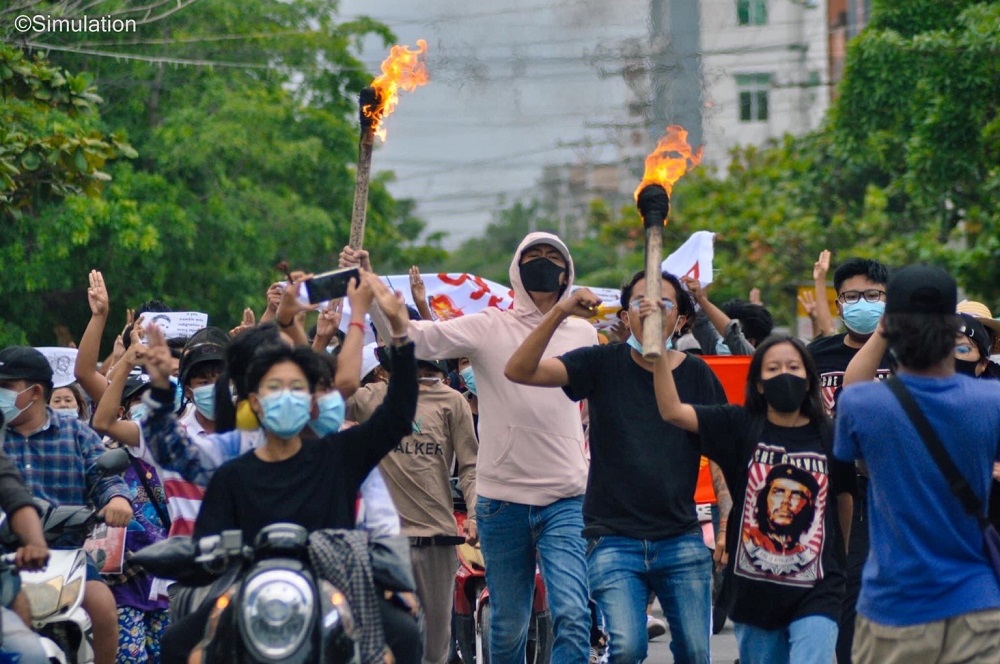 People hold torches during a protest in Mandalay, Myanmar June 14, 2021 in this picture obtained by Reuters.