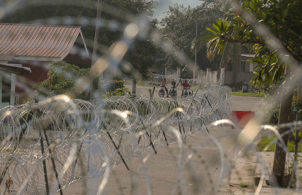 Barbed wire is seen around Kampung Datou00e2u20acu2122 Ahmad Said Tambahan 2 in Mukim (sub-district) Ulu Kinta following the implementation of enhanced movement control order (EMCO) to curb the spread of Covid-19 June 6, 2021. u00e2u20acu201d Picture by Farhan Najib  