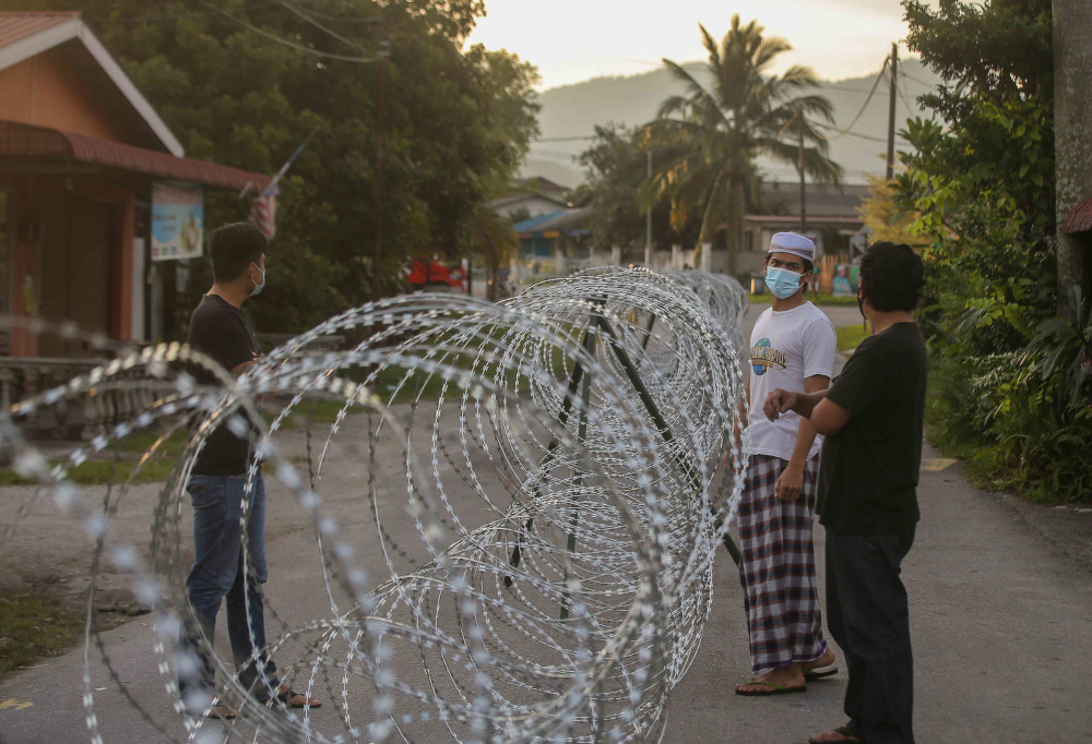 Barbed wire is seen around Kampung Datou00e2u20acu2122 Ahmad Said Tambahan 2 in Mukim (sub-district) Ulu Kinta following the implementation of enhanced movement control order (EMCO) to curb the spread of Covid-19 June 6, 2021. u00e2u20acu201d Picture by Farhan Najib  