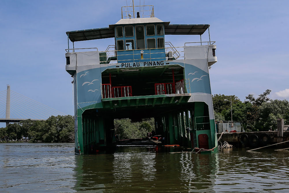 A Penang ferry is seen partly submerged near the Bagan Dalam Drydock on June 6, 2021. — Picture by Sayuti Zainudin