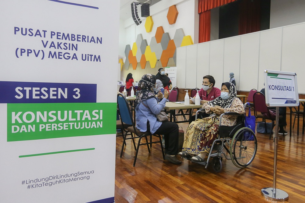 People receive their pre-treatment consultation before getting their Covid-19 vaccine jab, at the mega vaccination centre located at UiTM in Puncak Alam June 7, 2021. — Picture by Yusof Mat Isa