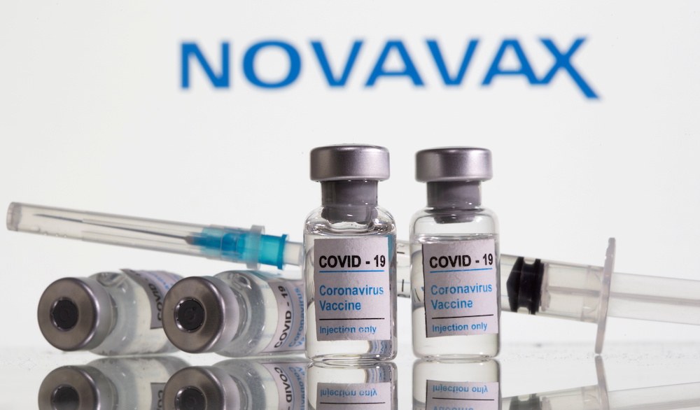 Vials labelled u00e2u20acu02dcCovid-19 Coronavirus Vaccineu00e2u20acu2122 and syringe are seen in front of displayed Novavax logo in this illustration taken, February 9, 2021. u00e2u20acu201d Reuters pic