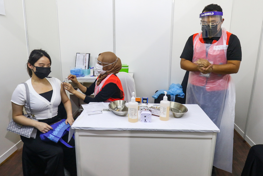 Covid 19 vaccine recipients take a jab at the Covid-19 vaccination centre in Bukit Jalil June 21, 2021. u00e2u20acu201d Picture by Ahmad Zamzahuri 