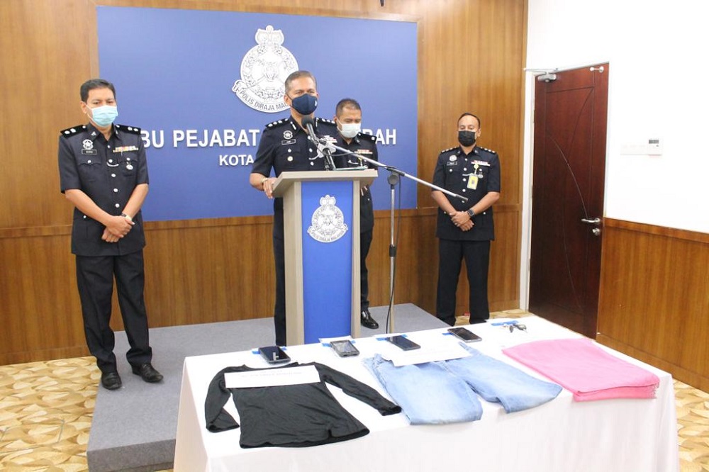 District police chief Assistant Commissioner Mohd Zaidi Abdullah (centre) with the seized items during a press conference in Kota Kinabalu June 21, 2021.