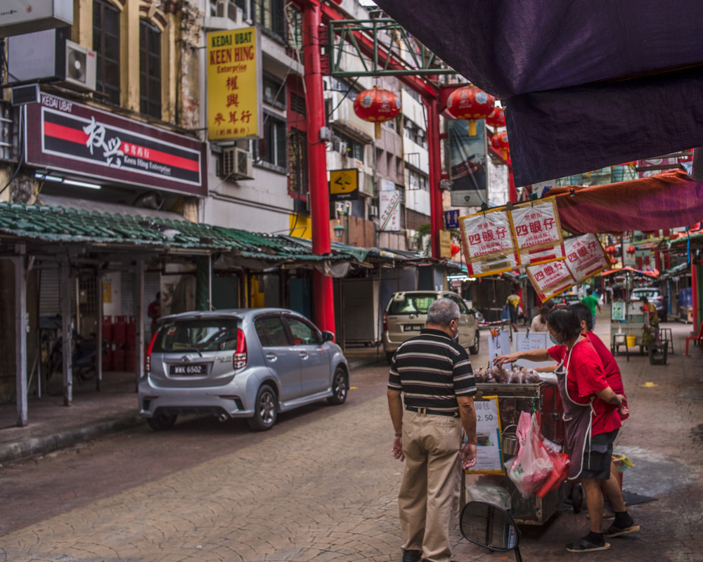 Petaling Street is mostly quiet except nearer towards the middle. Seen here is the Sze Ngan Chye stall, with the Madam Tang Muah Chee Queen stall in the backdrop also open. u00e2u20acu201d Picture by Shafwan Zaidon