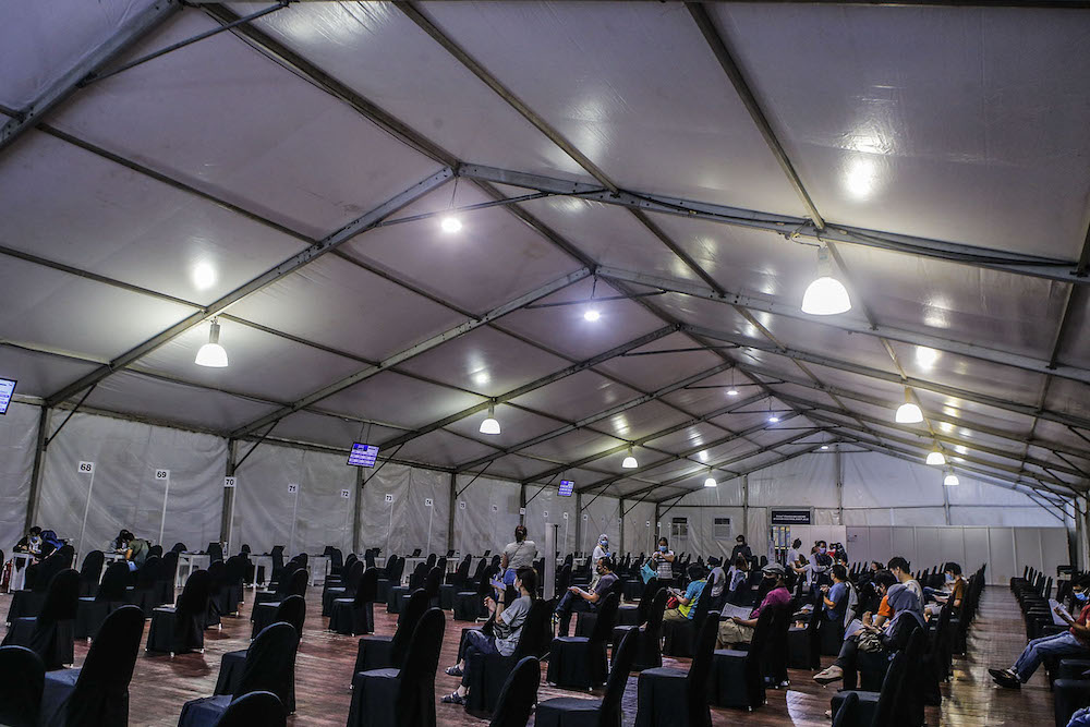 Vaccine recipients rest after receiving the injection at the vaccination centre (PPV) in Bukit Jalil June 27, 2021. u00e2u20acu2022  Picture by Hari Anggaran
