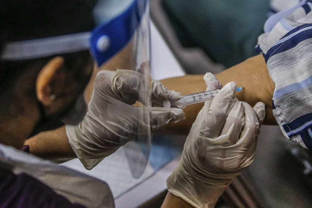 Health workers administer Covid-19 vaccine doses at the Selangor Covid-19 Vaccination Programme at Dewan Seri Siantan in Selayang June 28, 2021. u00e2u20acu2022 Picture by Hari Anggara