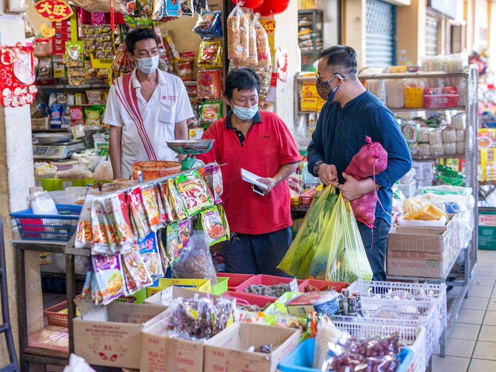 Sim took Ah Soon to buy ingredients to prep for his new stall’s opening this evening. —Picture from Facebook/Steven Sim