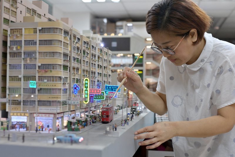 This photo taken on June 23, 2021 shows model maker Maggie Chan of Toma Miniatures working at her studio in Hong Kong. — AFP pic