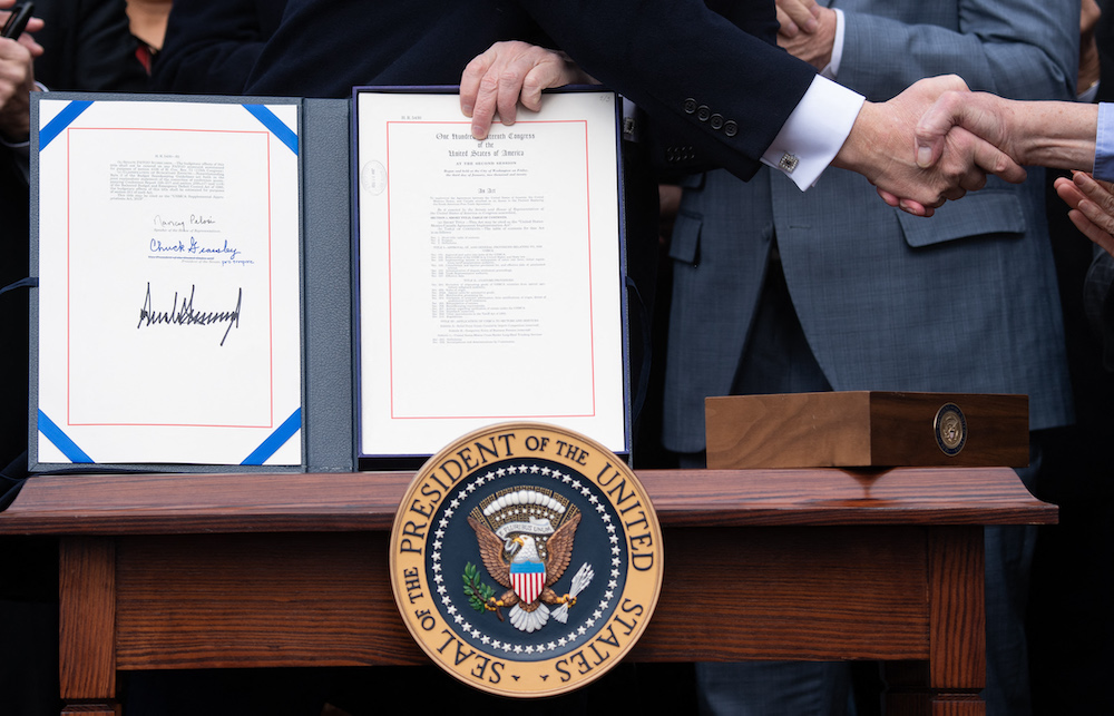In this file photo taken on January 29, 2020, US President Donald Trump holds the signed United States-Mexico-Canada Trade Agreement, known as USMCA. u00e2u20acu201d AFP pic