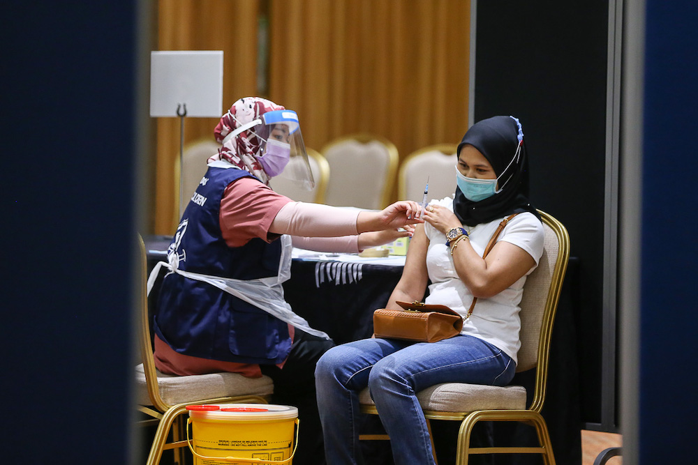Manufacturing workers in Selangor receive their Pikas Covid-19 jab at the vaccination centre at Setia City Convention Centre in Shah Alam June 28, 2021. u00e2u20acu201d Picture by Yusof Mat Isa