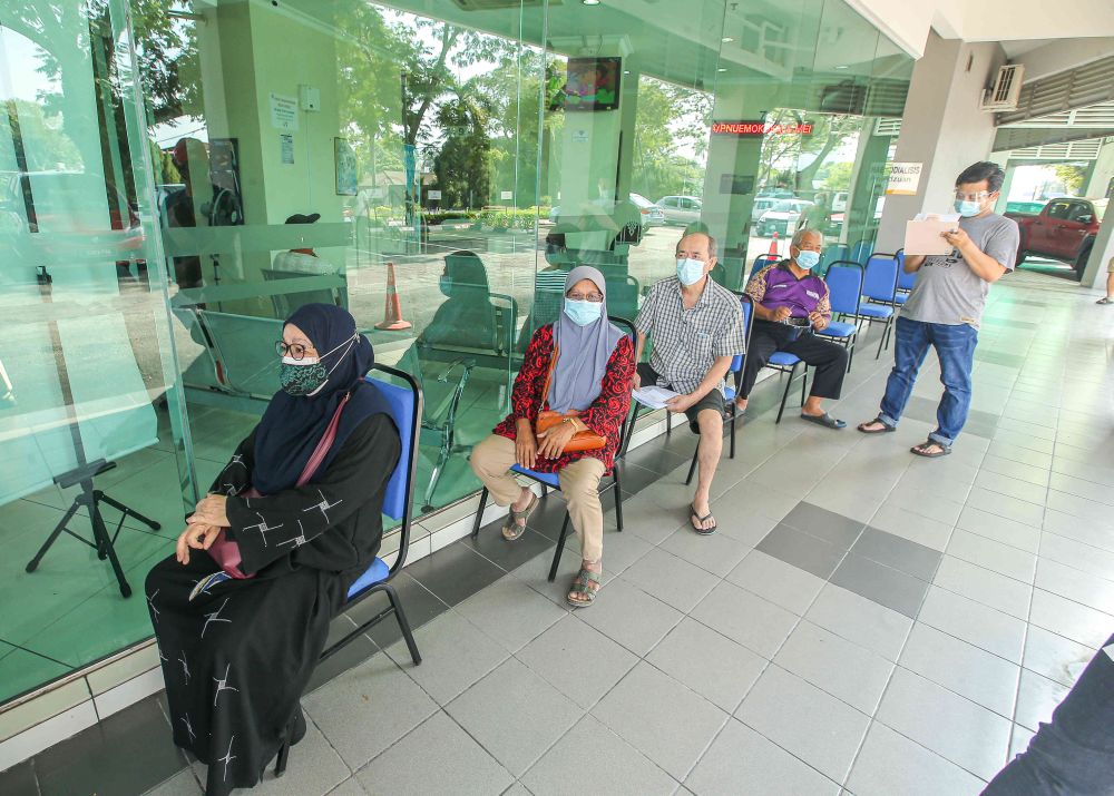People wait to receive their Covid-19 jab at the Ar-Ridzuan Medical Centre in Ipoh June 7, 2021. u00e2u20acu201d Picture by Farhan Najib