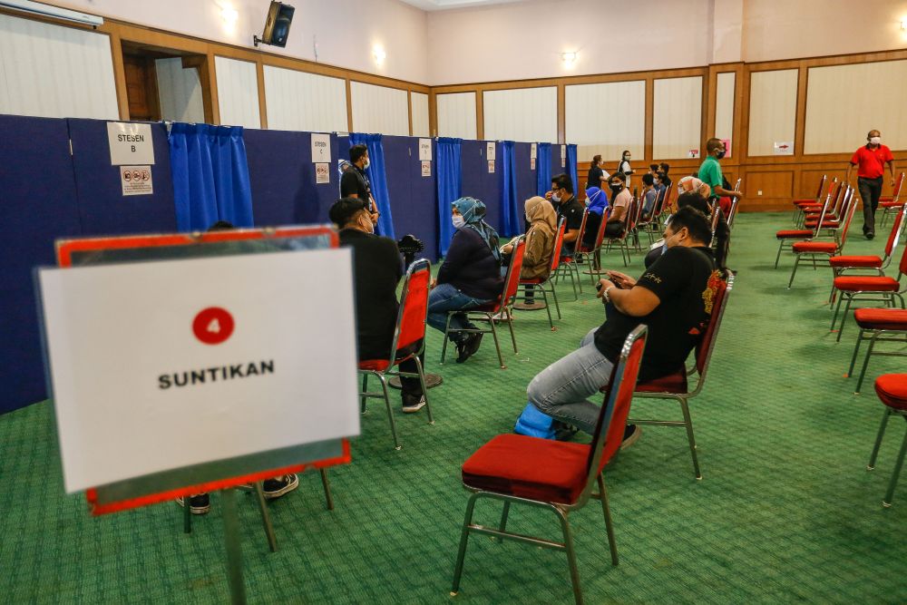 Factory workers wait to receive their Covid-19 jab at the Bukit Jawi Golf Resort in Penang June 16, 2021. u00e2u20acu201d Picture by Sayuti Zainudinnn