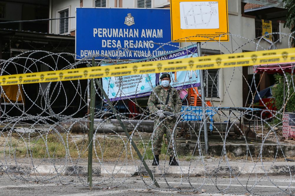 An Armed Forces personnel patrols the vicinity of the Desa Rejang People's Housing Project in Kuala Lumpur amid the enhanced movement control order June 21, 2021. u00e2u20acu201d Picture by Yusof Mat Isa
