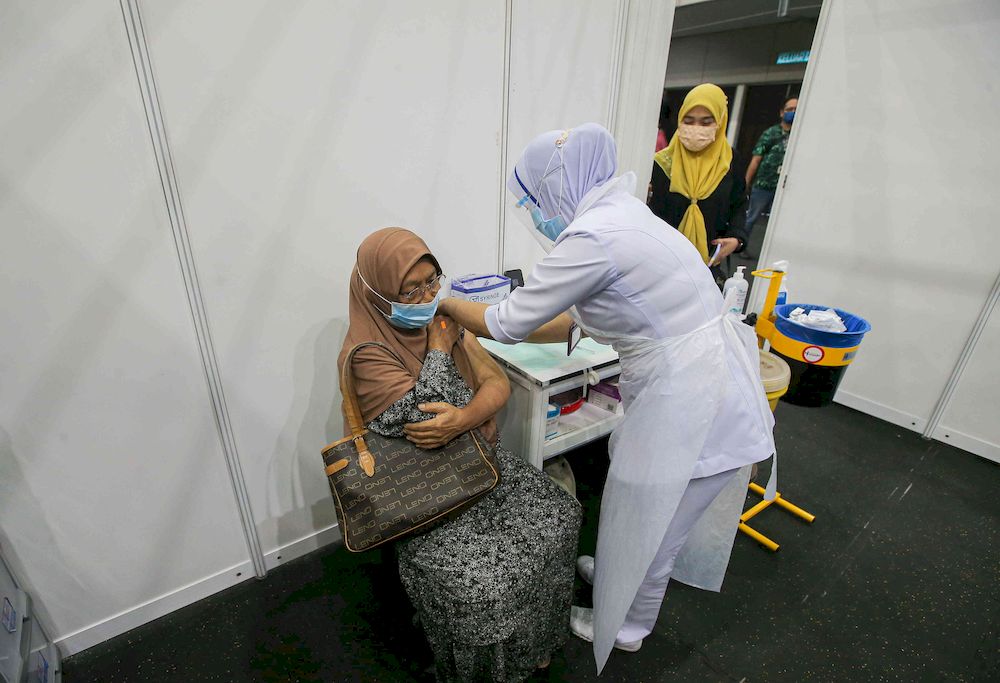 The second phase of vaccination under the National Immunisation Programme going smoothly according to schedule at the vaccination centre (PPV) Stadium Indera Mulia in Ipoh, Perak on June 4, 2021. — Picture by Farhan Najib