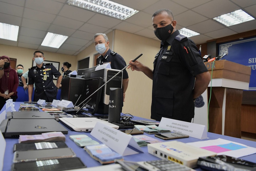 Johor police chief Datuk Ayob Khan Mydin Pitchay showing some of the confiscated electronic devices, at a press conference in Johor Baru June 28, 2021. u00e2u20acu201d Bernama pic