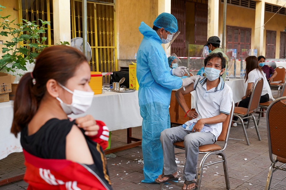 A Cambodian army member vaccinates a person inside a red zone with strict lockdown measures, amidst the latest outbreak of the Covid-19, in Phnom Penh, Cambodia May 1, 2021. u00e2u20acu2022 Reuters pic