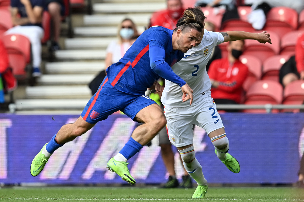 England striker Jack Grealish is fouled in the penalty area by Romaniau00e2u20acu2122s defender Tiberiu Capusa during the international friendly football match between England and Romania at the Riverside Stadium in Middlesbrough, north-east England June 6, 2021. u00e2u20acu201d