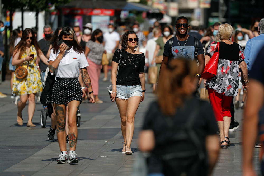 People, some without protective masks, walk downtown Madrid, as masks are no longer required outdoors from June 26, amid the coronavirus disease pandemic, Spain, June 26, 2021. u00e2u20acu201d Reuters picnnn