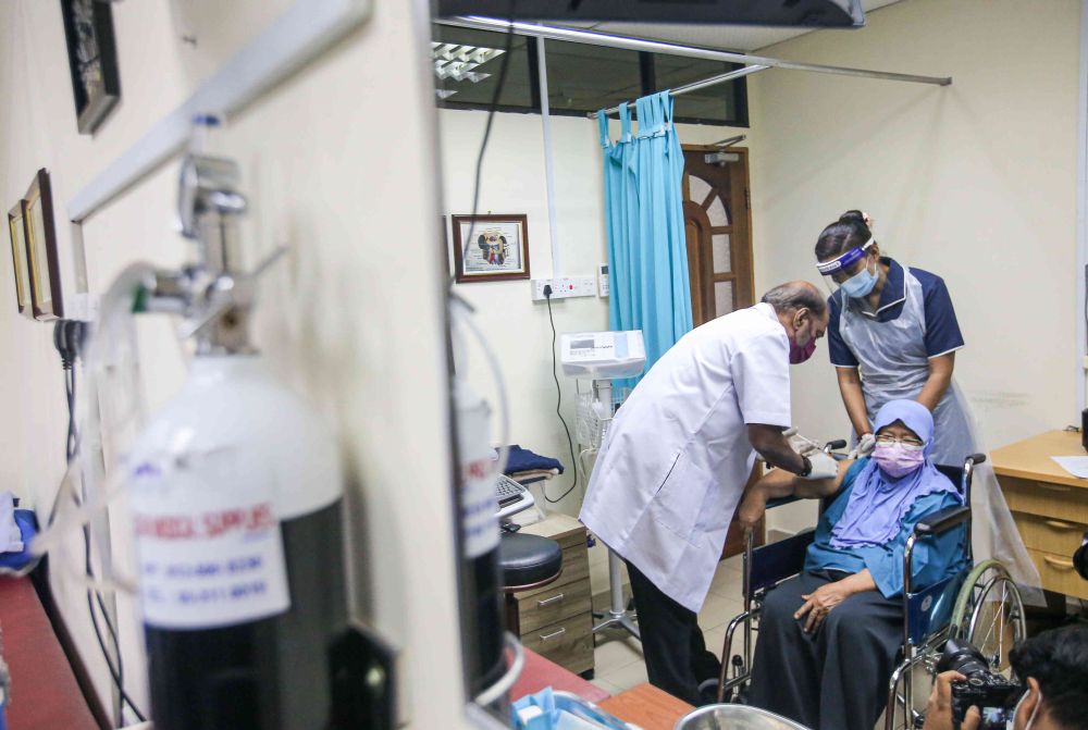 A senior citizen receives a dose of the Covid-19 vaccine at a clinic under the Perak Medical Centre Group of Clinics in Ipoh June 15, 2021. u00e2u20acu201d Picture by Farhan Najib