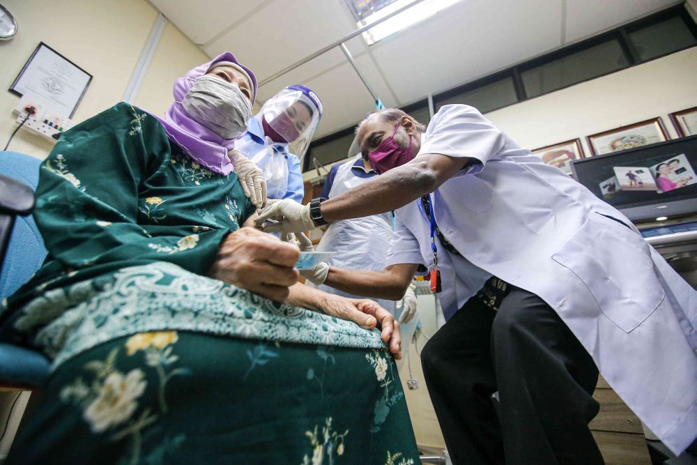 A senior citizen receives a dose of the Covid-19 vaccine at a clinic under the Perak Medical Centre Group of Clinics in Ipoh June 15, 2021. u00e2u20acu201d Picture by Farhan Najib