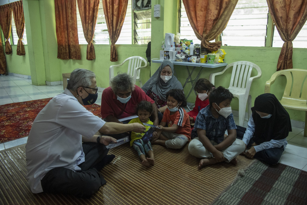Senior Minister (Security Cluster) Datuk Seri Ismail Sabri Yaakob presenting donations to the children of Private Suria Mohamad Hassan after paying a charity visit to the military retiree at the Sri Johor Public Housing in Kuala Lumpur, June 22, 2021. u00e2u20acu201d