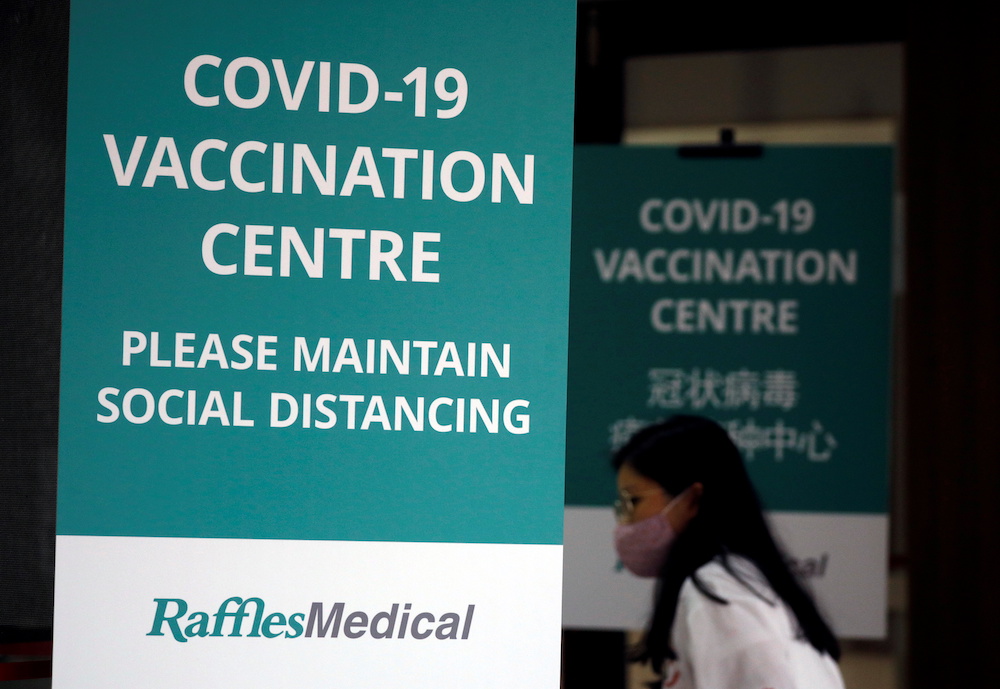 A woman walks into a newly set up coronavirus disease vaccination centre which will be opened to the public the day after, in Singapore January 26, 2021. u00e2u20acu201d Reuters picnn