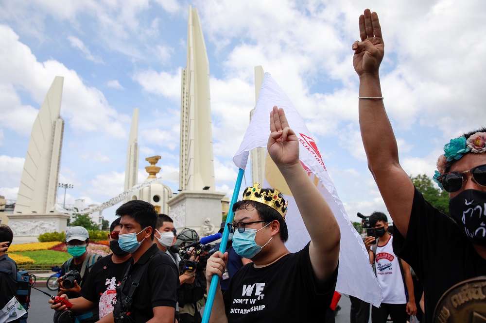 Protest leader Parit u00e2u20acu02dcPenguinu00e2u20acu2122 Chiwarak (with crown) shows the three-finger salute during a demonstration to mark the 89th anniversary of the abolition of absolute monarchy in Bangkok, Thailand June 24, 2021. u00e2u20acu2022 Reuters pic